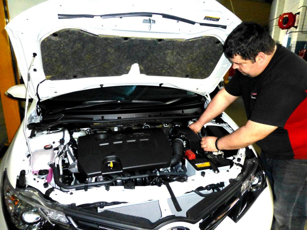 Herdsman Auto Service mechanic working on car engine bay for auto electrical and air conditioning service Perth